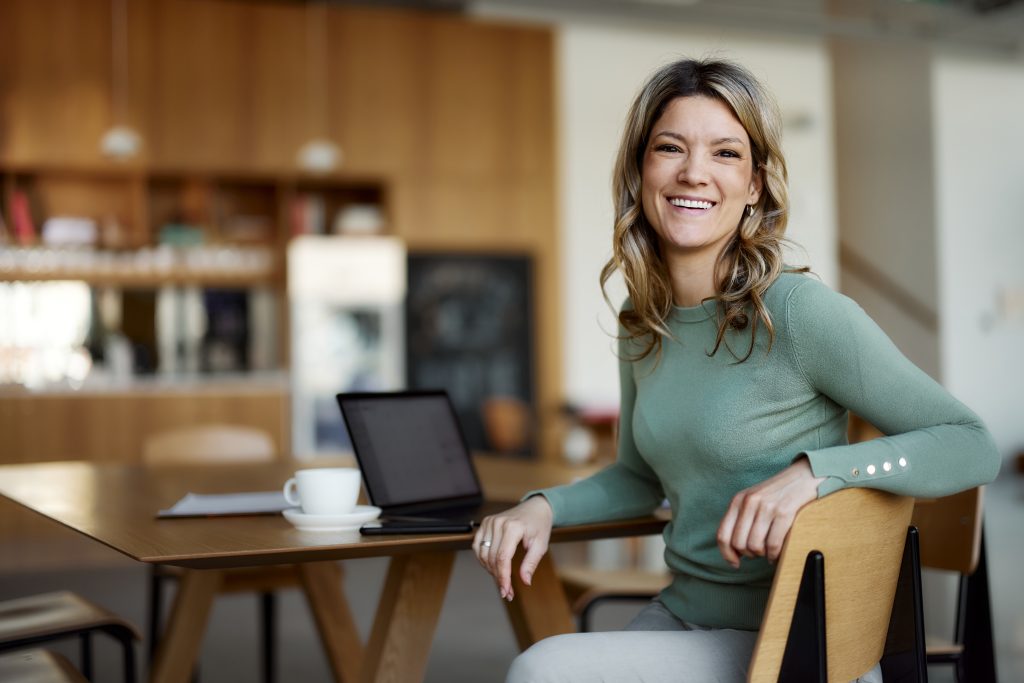 Happy casual businesswoman working at casual office.