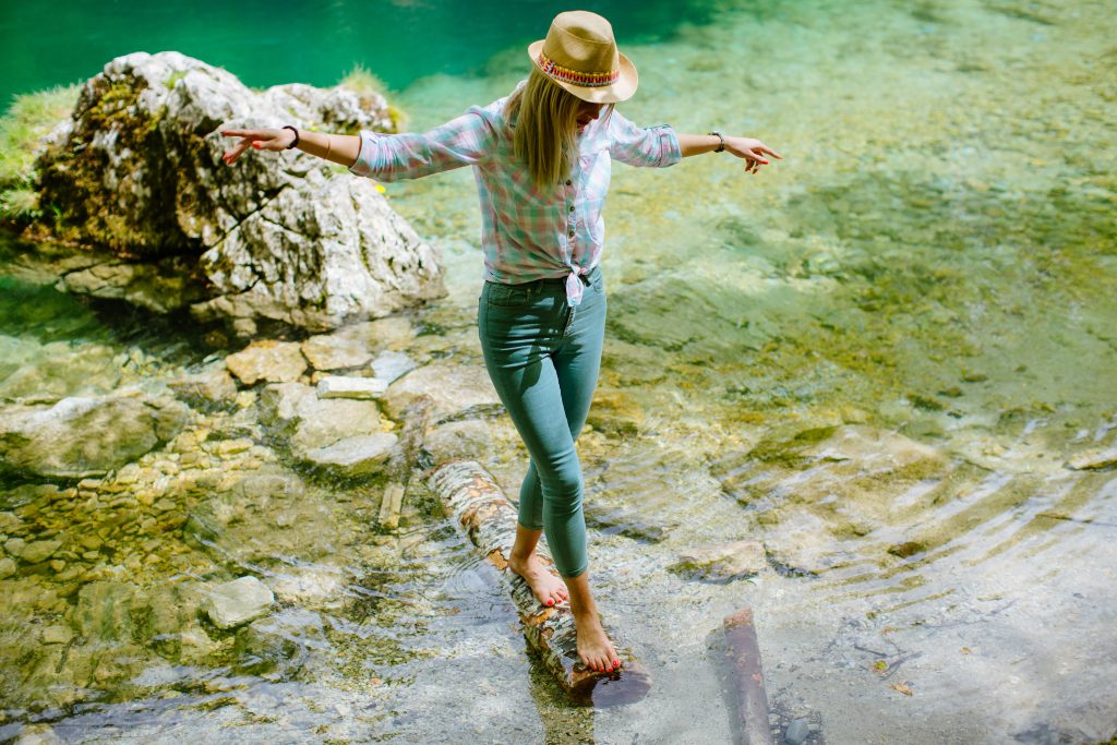 woman balancing on wood log Testing Balance